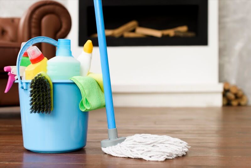 Bucket with cleaning products and a mop ready for the service